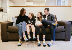 Eamonn Millar, 10, and his family, wearing socks Eamonn designed, are grateful for the support the BC Children's Hospital team has provided during Eamonn's cancer journey. Courtesy the Millar family